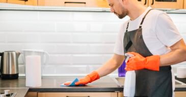 man-cleaning-cabinet-with-rag man-cleaning-cabinet-with-rag